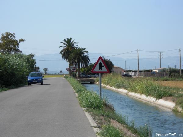Bewässerungskanal, neben Straße mit Brücke
